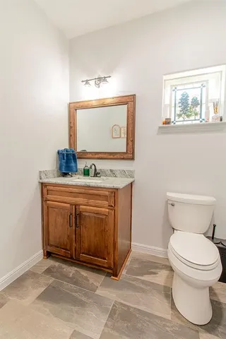 a living room with fireplace furniture and a large window