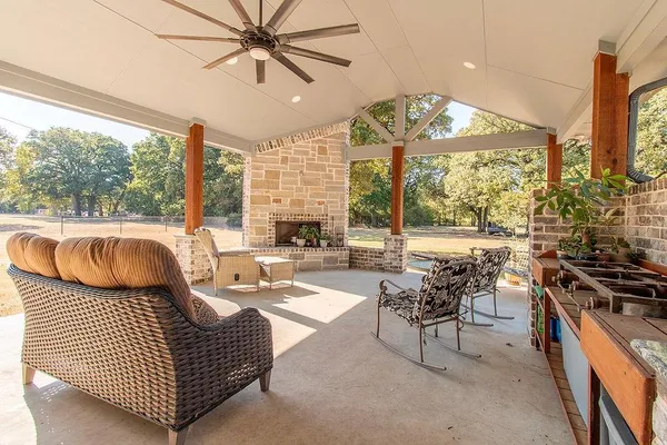 a living room with furniture a large window with kitchen view