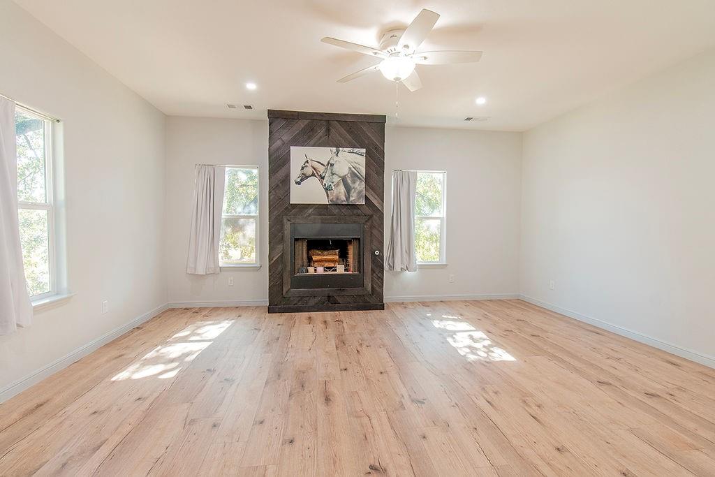 280 Lanier Road Combine, TX 75159 - Photo 7 of 36 an empty room with windows fireplace and a sink