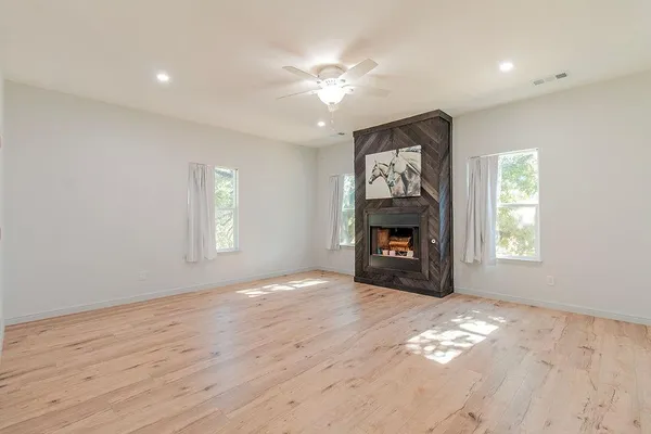 a spacious bathroom with a granite countertop sink and a mirror