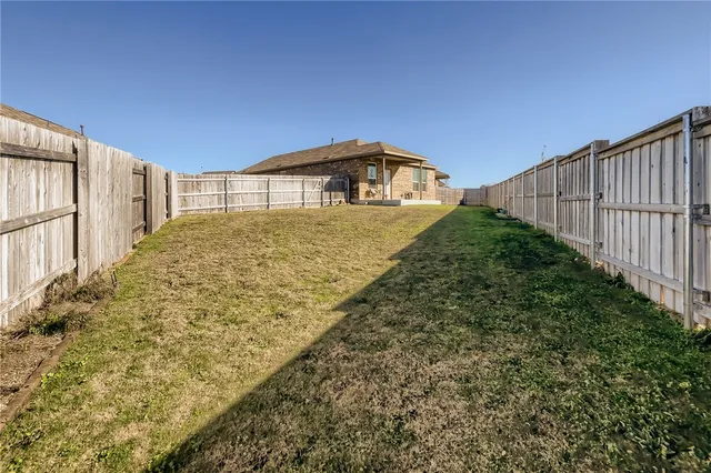 a view of a backyard with fence