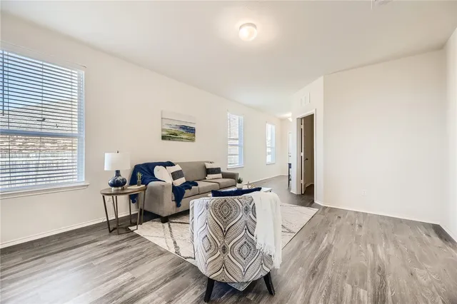 a living room with furniture and wooden floor