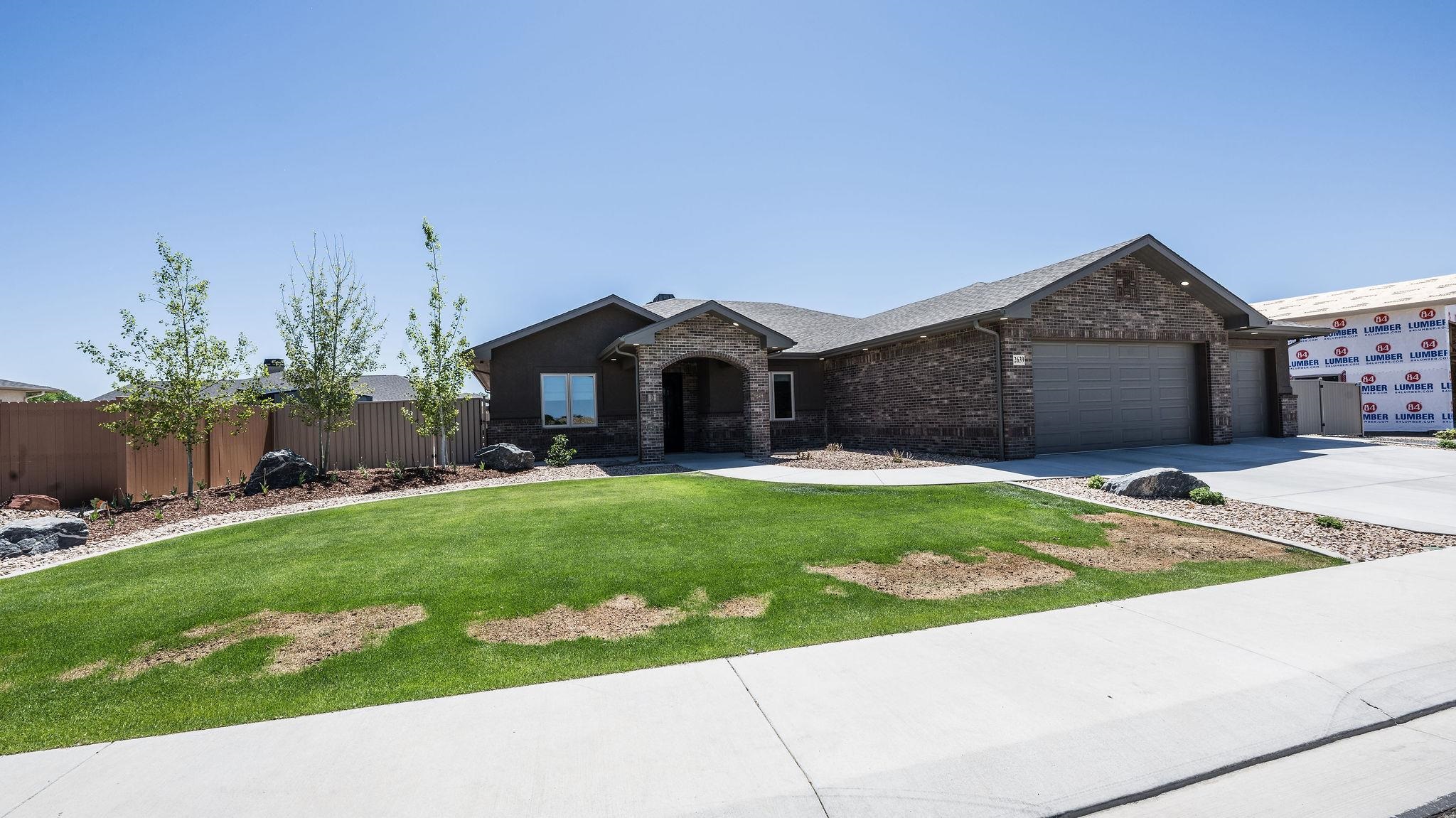 2639 Emerald Ridge Lane Grand Junction, CO 81506 - Photo 40 of 42 a front view of a house with a garden and yard