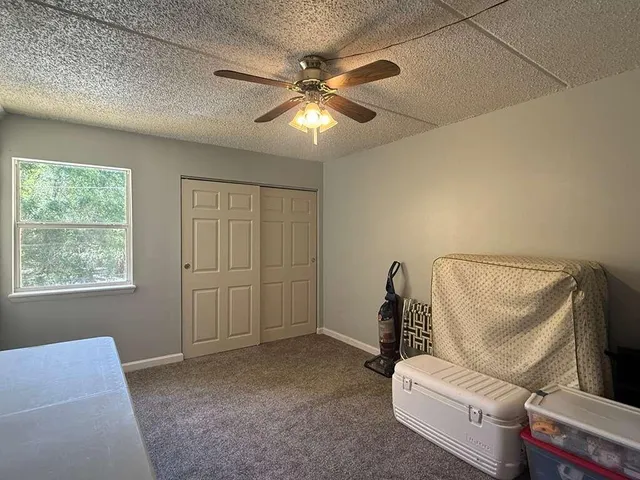 a view of room with a ceiling fan