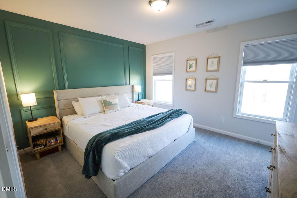 230 South Raleigh Street Angier, NC 27501 - Photo 24 of 38 a bedroom with a bed and a window