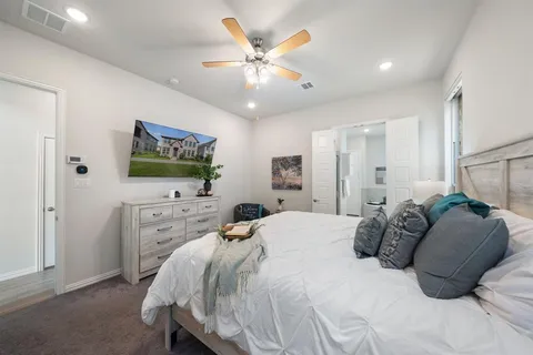 a bedroom with a bed and a flat screen tv