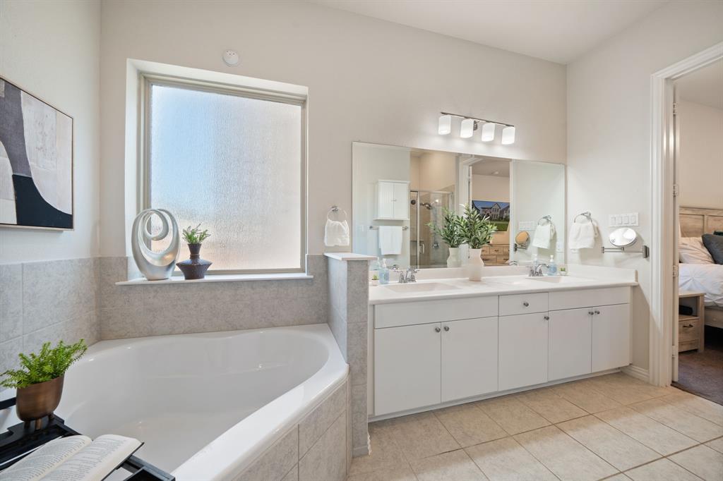 744 Patriot Lane Irving, TX 75060 - Photo 20 of 40 a bathroom with a tub a sink and a window