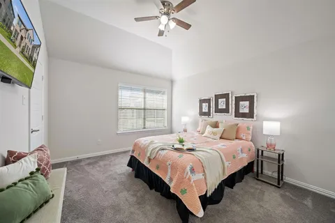 a bedroom with a bed and a chandelier