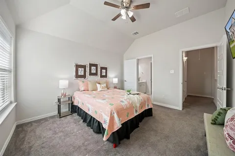 a bedroom with a bed and a chandelier