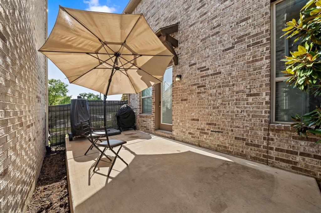 744 Patriot Lane Irving, TX 75060 - Photo 33 of 40 a view of a patio with a table and chairs under an umbrella