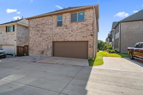 a view of a house with a yard and front door