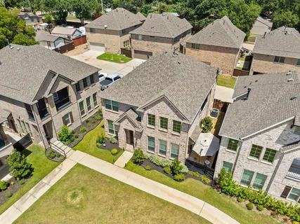 an aerial view of a house with a swimming pool and outdoor seating