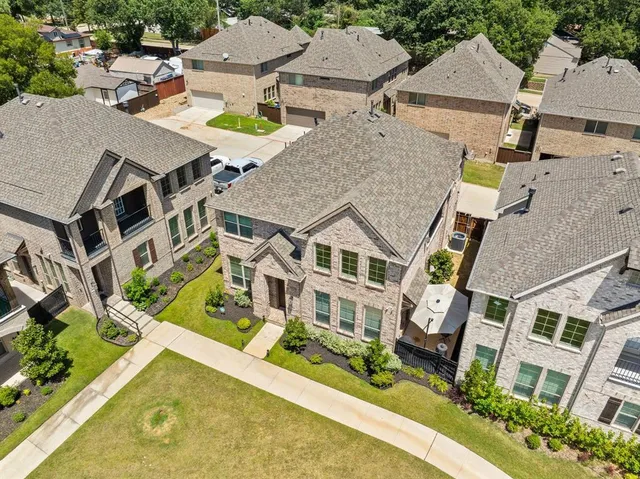 an aerial view of a house with a swimming pool and outdoor seating