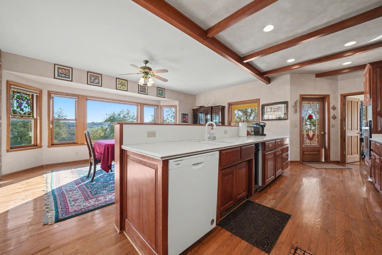 22707 Upton Road Plymouth, CA 95669 - Photo 43 of 99 a large kitchen with stainless steel appliances granite countertop a lot of counter space and wooden floors