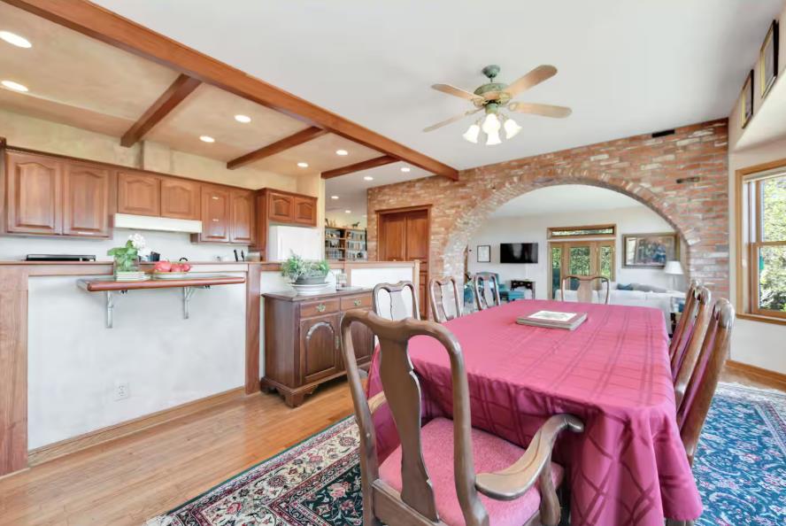 22707 Upton Road Plymouth, CA 95669 - Photo 6 of 26 a dining room with furniture a kitchen view and a chandelier