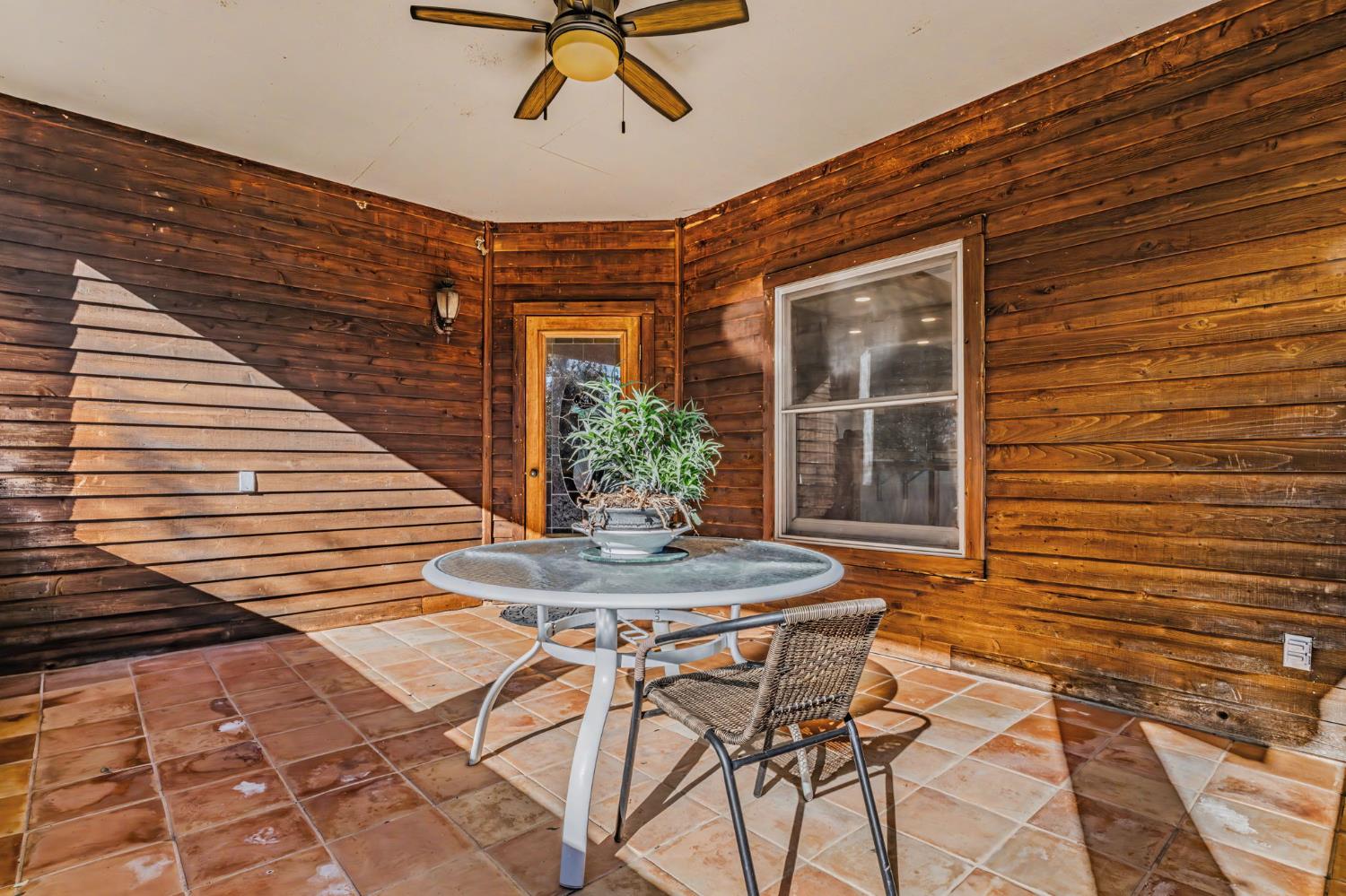 22707 Upton Road Plymouth, CA 95669 - Photo 66 of 99 a patio with table and chairs and potted plants