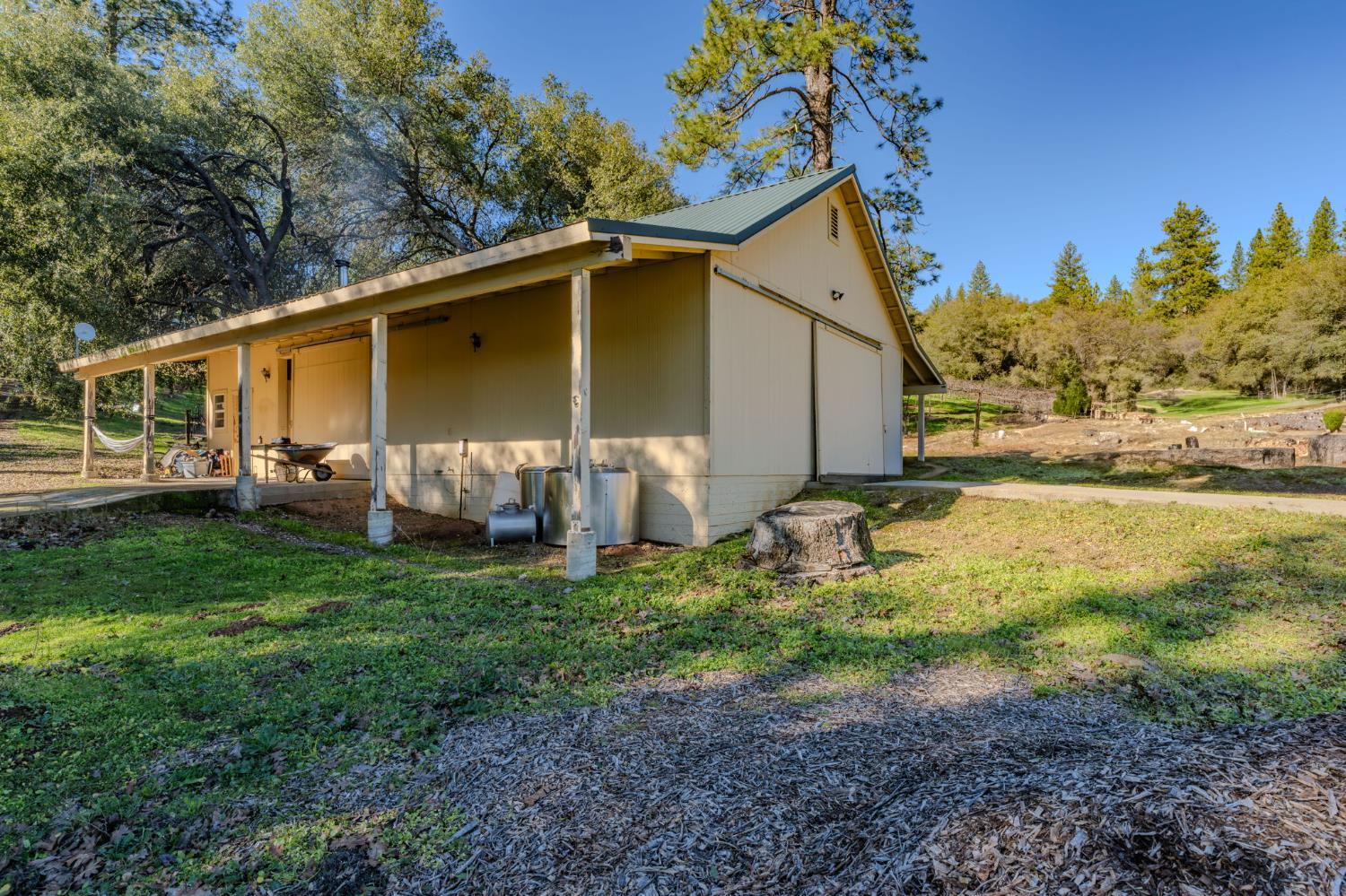 22707 Upton Road Plymouth, CA 95669 - Photo 72 of 99 a view of a backyard with plants and a patio