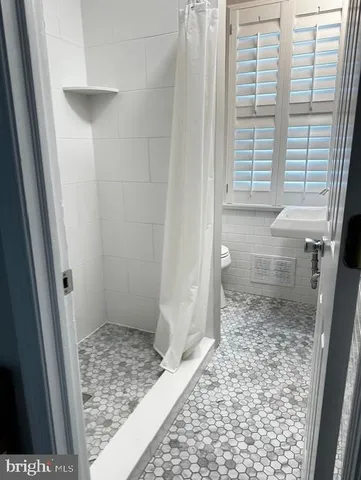 a bathroom with a toilet and a sink