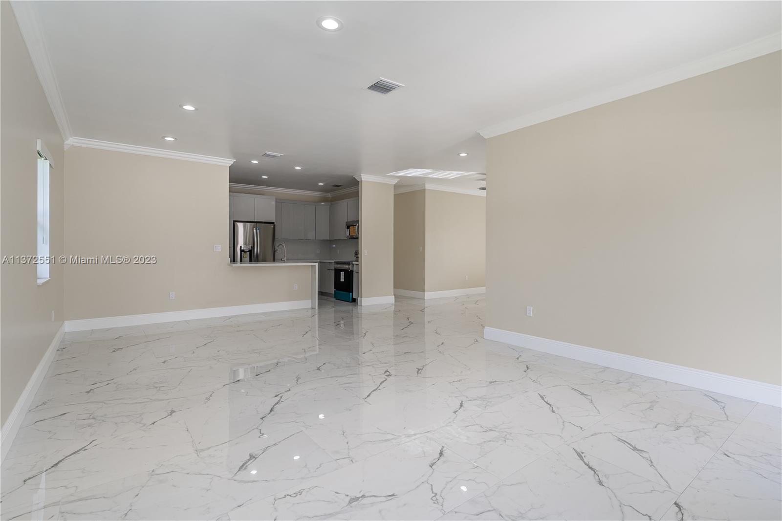 6109 Edwards Road Margate, FL 33063 - Photo 22 of 31 wooden floor in an empty room with a kitchen