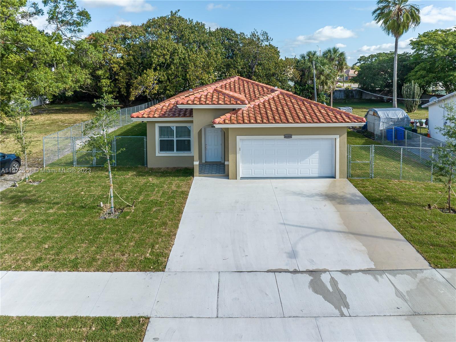 6109 Edwards Road Margate, FL 33063 - Photo 3 of 31 a front view of a house with garden