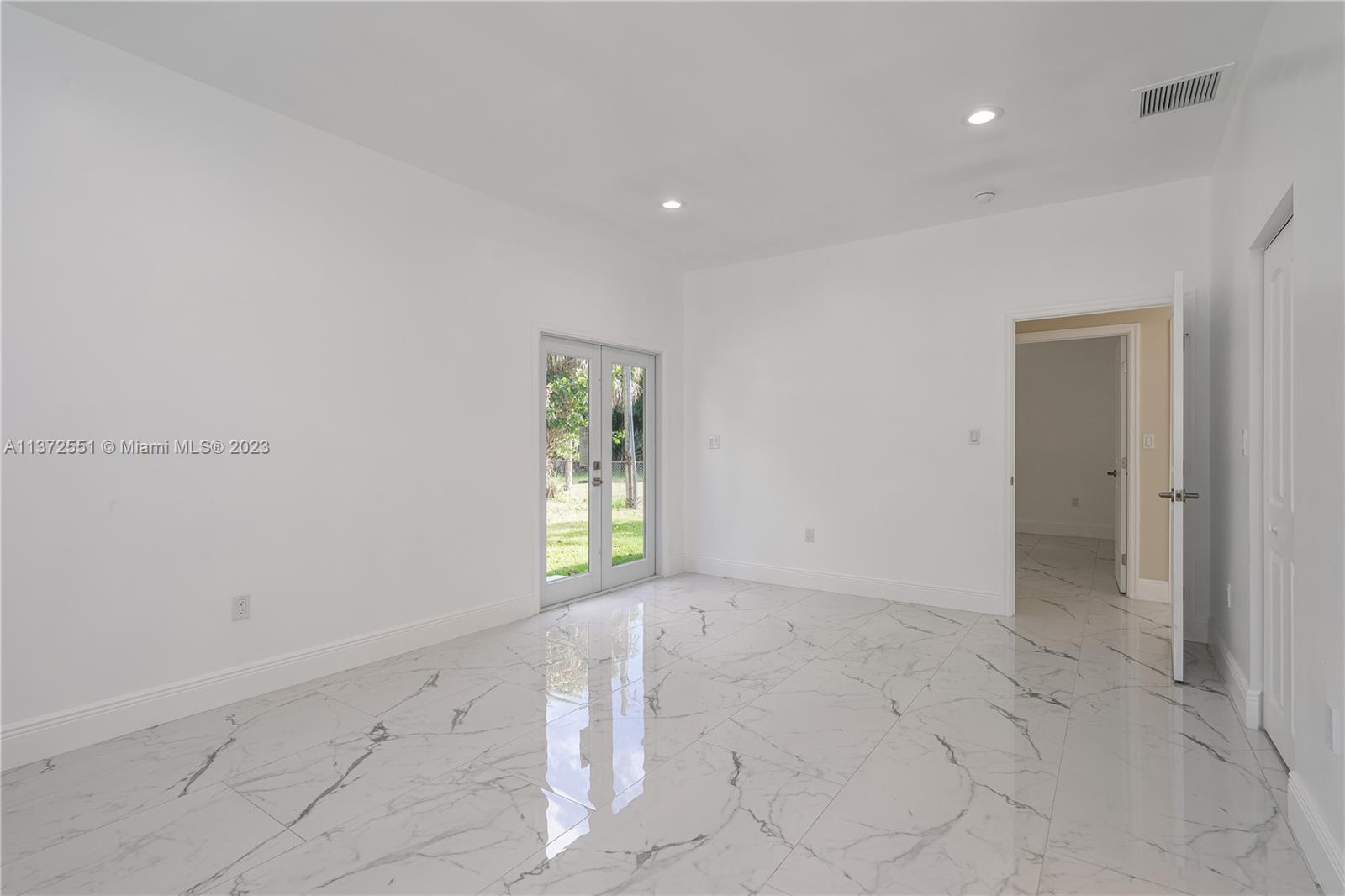 6109 Edwards Road Margate, FL 33063 - Photo 31 of 31 an empty room with windows