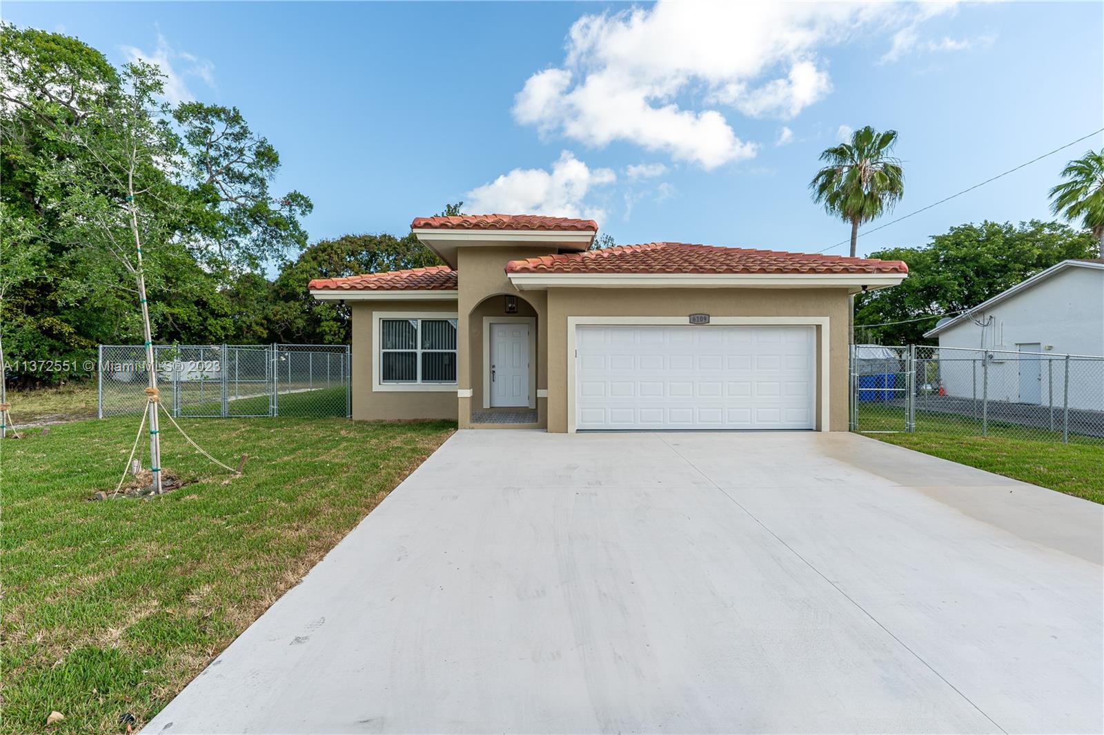 6109 Edwards Road Margate, FL 33063 - Photo 4 of 31 a front view of a house with a yard and garage