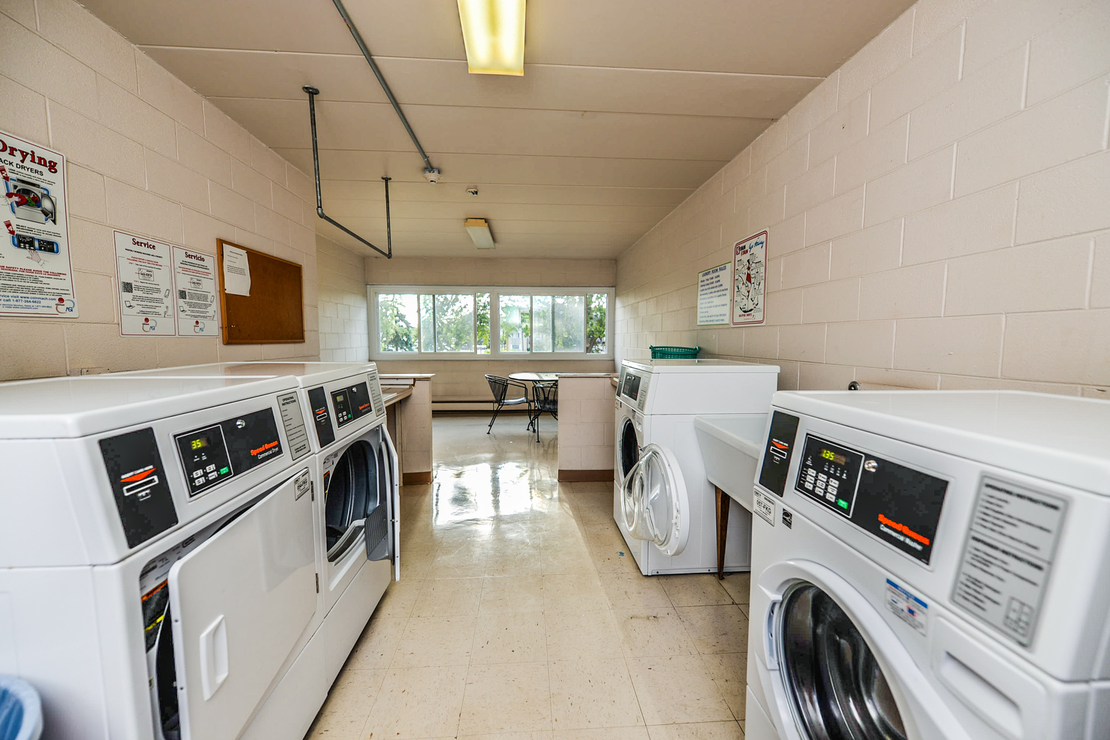 2226 South Goebbert Road, Unit 270 Arlington Heights, IL 60005 - Photo 20 of 27 a utility room with dryer washer and a view of living room