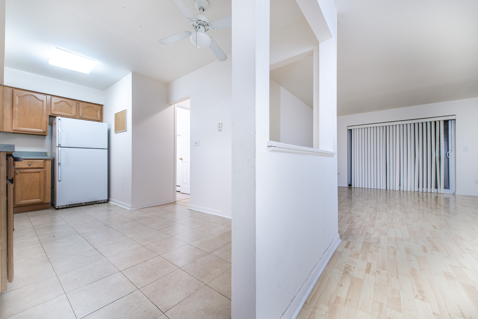 2226 South Goebbert Road, Unit 270 Arlington Heights, IL 60005 - Photo 6 of 27 a view of a kitchen with refrigerator and white cabinets