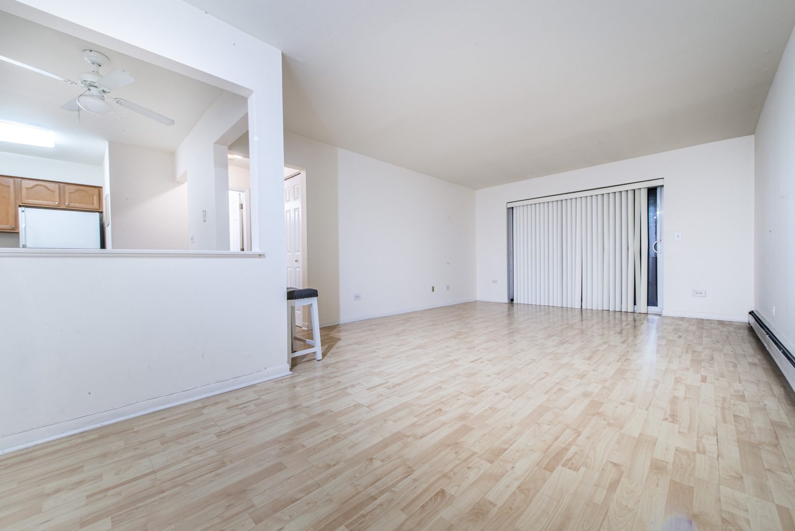 2226 South Goebbert Road, Unit 270 Arlington Heights, IL 60005 - Photo 7 of 27 an empty room with wooden floor and mirror