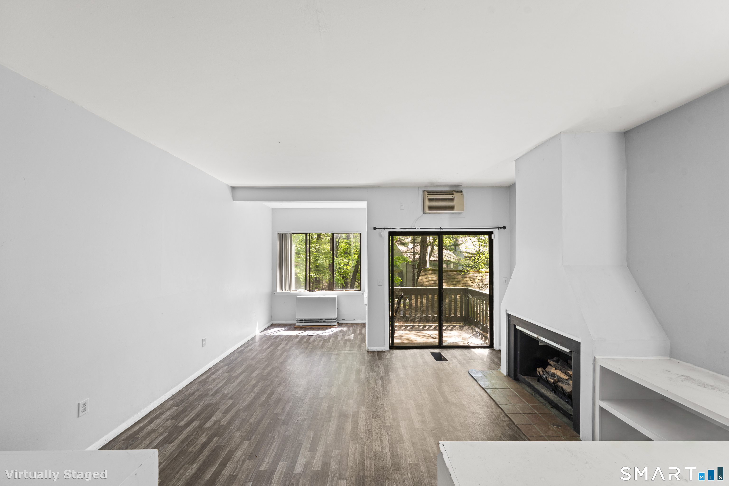 39 Evergreen Road, Unit 39 Torrington, CT 06790 - Photo 22 of 27 a view of empty room with wooden floor and fireplace