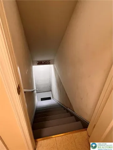 a large bedroom with a bed and a flat screen tv