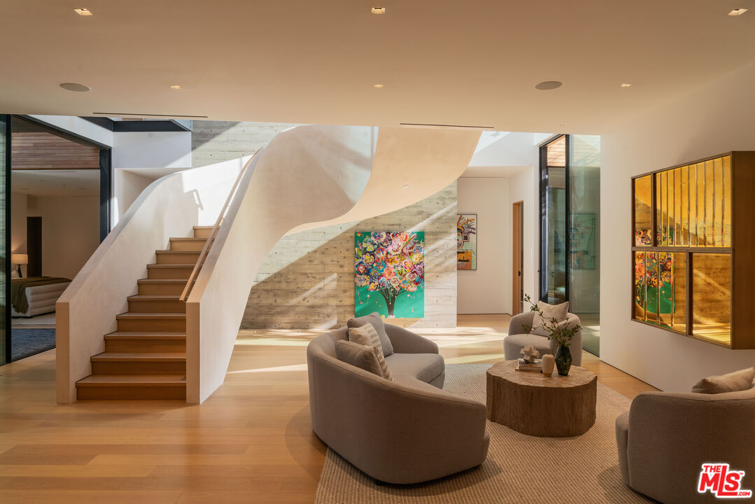 1520 Carla Ridge Beverly Hills, CA 90210 - Photo 16 of 24 a living room with furniture and a large window
