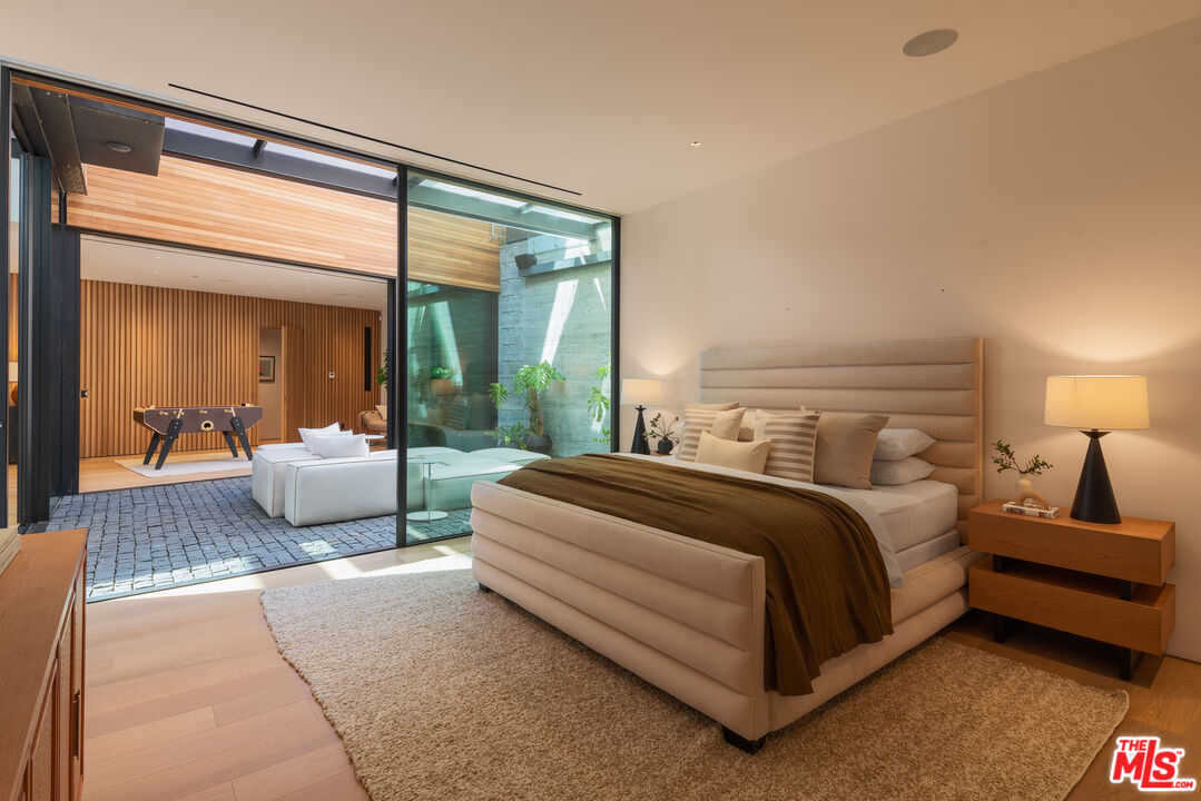1520 Carla Ridge Beverly Hills, CA 90210 - Photo 20 of 24 a bedroom with a large bed and a large window