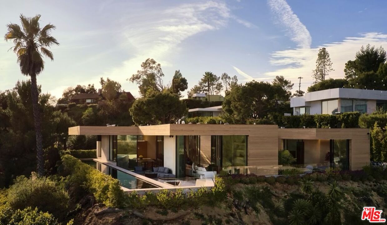 1520 Carla Ridge Beverly Hills, CA 90210 - Photo 2 of 24 a aerial view of a house with a yard and potted plants