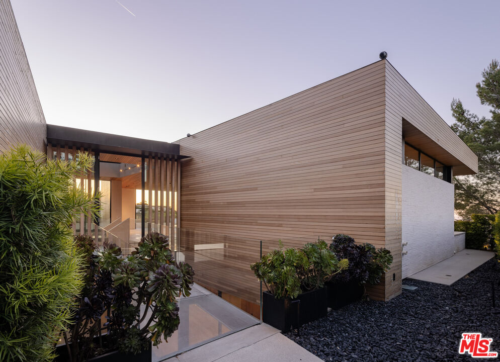 1520 Carla Ridge Beverly Hills, CA 90210 - Photo 24 of 24 a potted plant sitting in front of a house