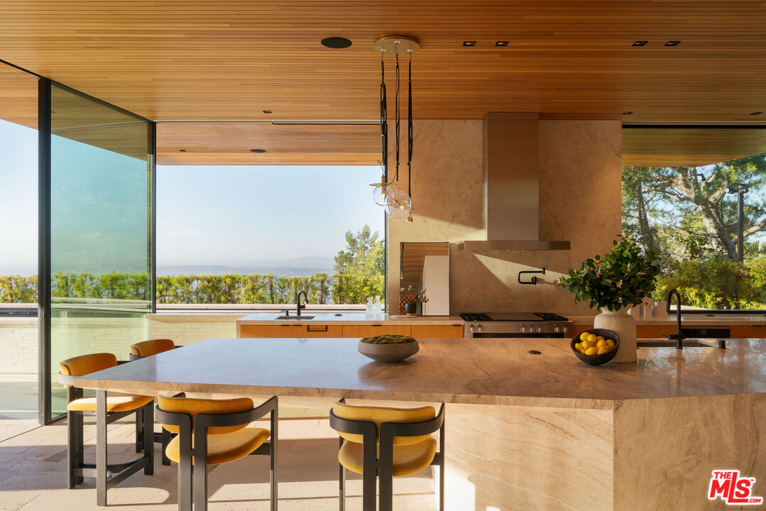 1520 Carla Ridge Beverly Hills, CA 90210 - Photo 3 of 24 a balcony with table and chairs