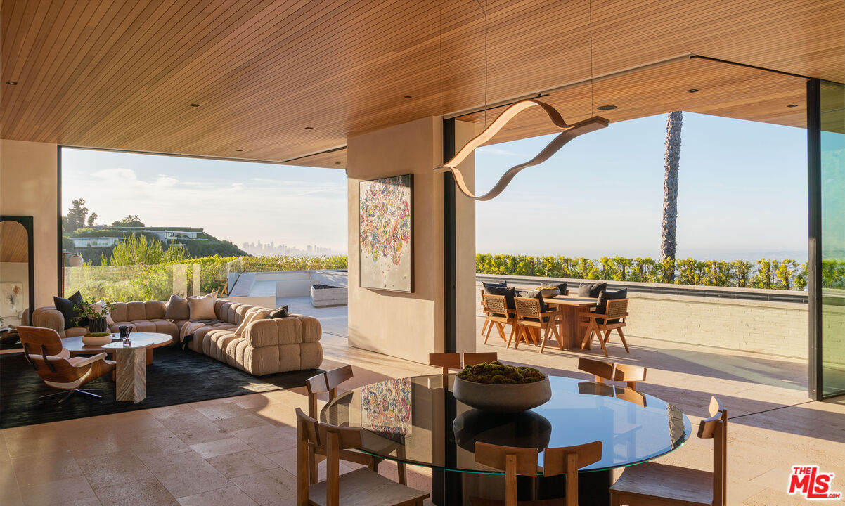 1520 Carla Ridge Beverly Hills, CA 90210 - Photo 4 of 24 a view of a balcony with furniture and floor to ceiling window