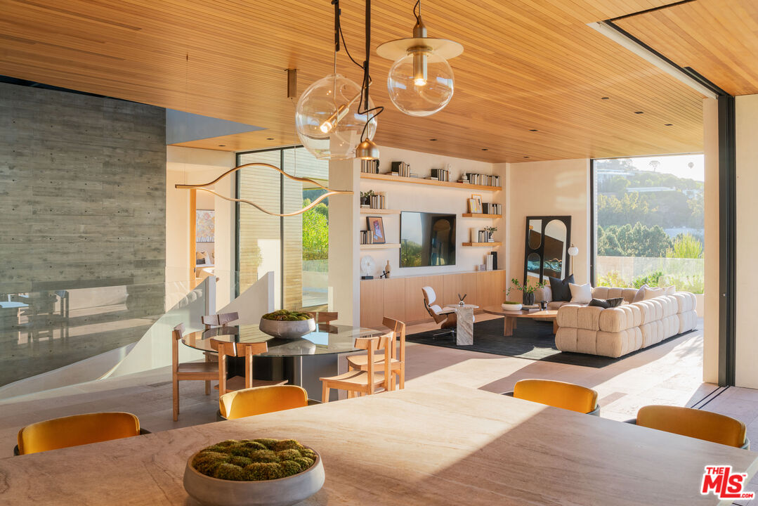 1520 Carla Ridge Beverly Hills, CA 90210 - Photo 7 of 24 a living room with furniture a fireplace and a table