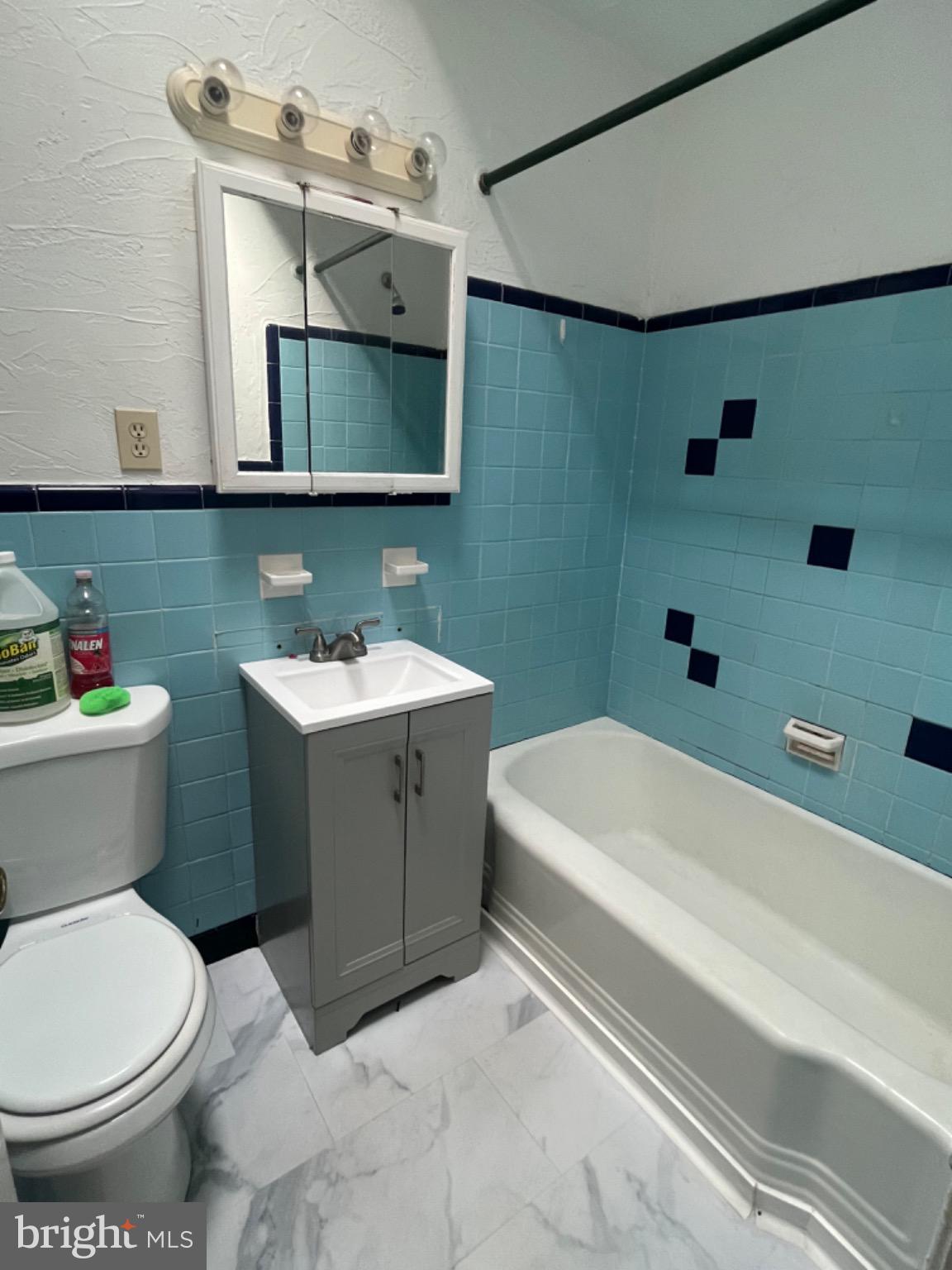 914 East Sharpnack Street Philadelphia, PA 19150 - Photo 5 of 6 Charming bathroom with retro blue tiles.