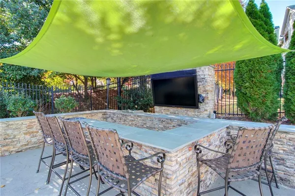 a front view of a house with swimming pool having outdoor seating