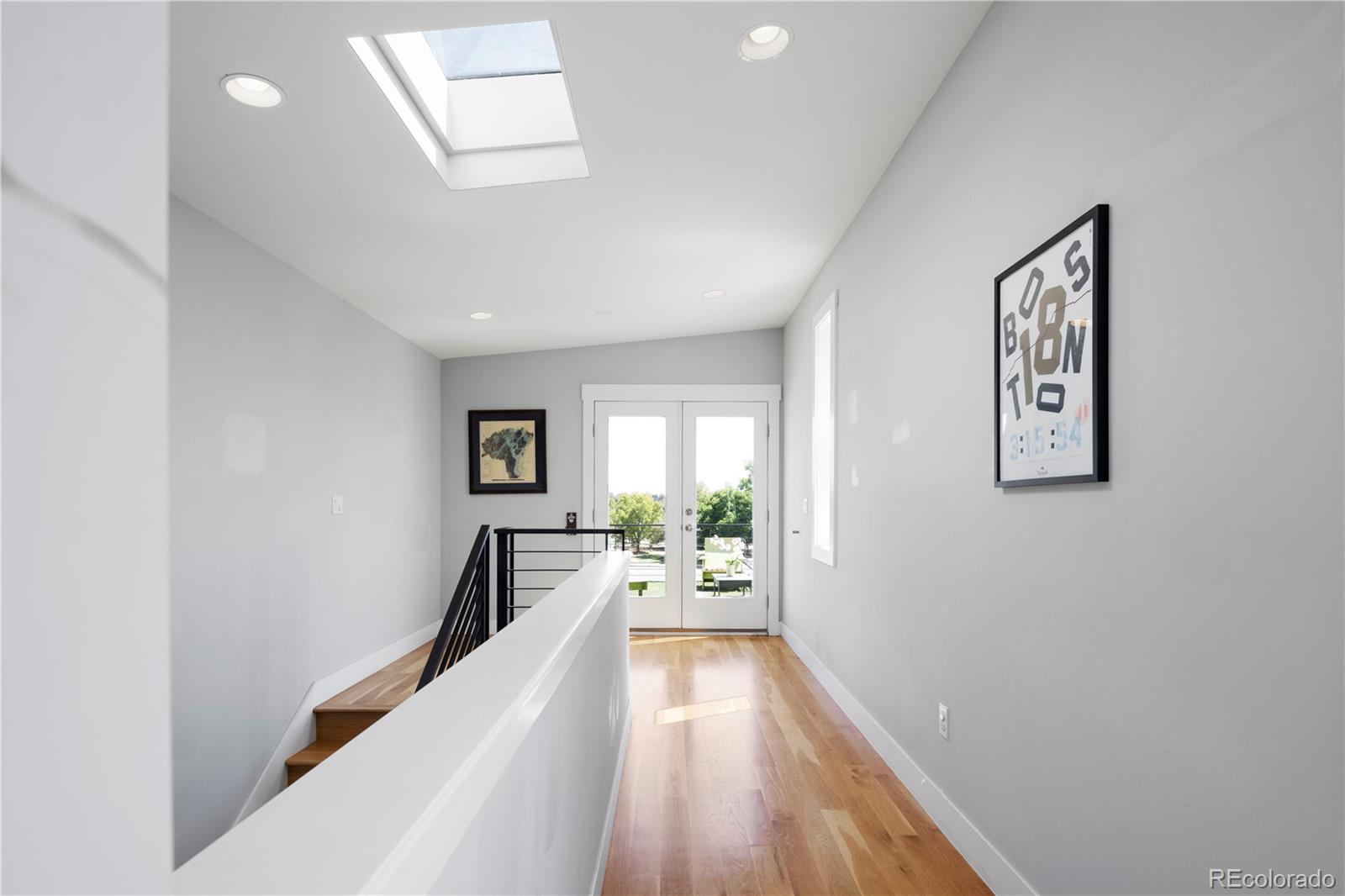 2436 Ames Street Edgewater, CO 80214 - Photo 27 of 34 a view of a hallway with wooden floor and a living room