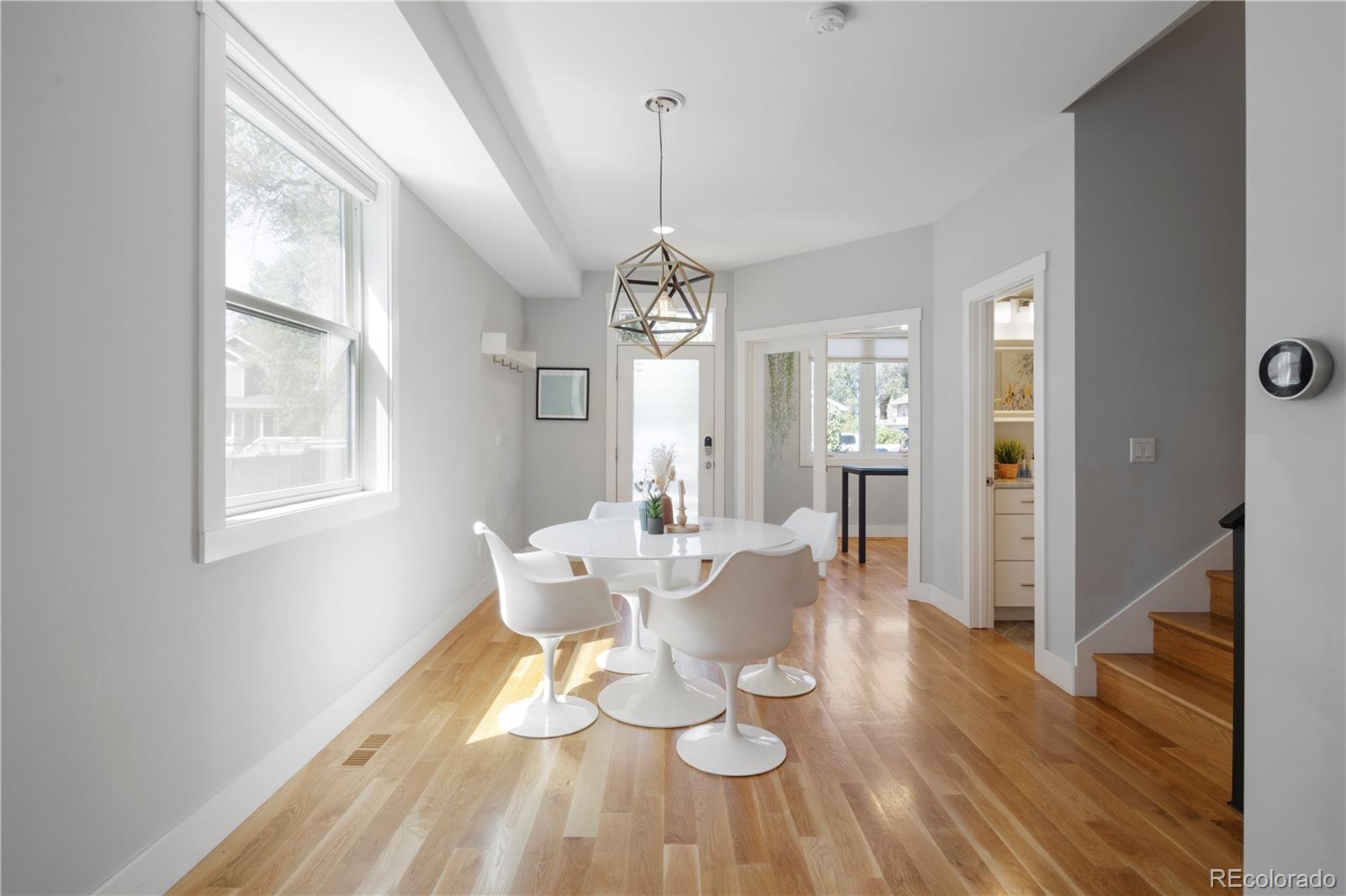 2436 Ames Street Edgewater, CO 80214 - Photo 3 of 34 a view of a dining room with furniture window and wooden floor
