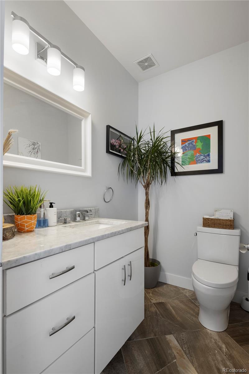 2436 Ames Street Edgewater, CO 80214 - Photo 5 of 34 a bathroom with a toilet sink and mirror