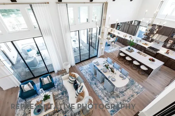 a living room with chairs and a wooden floor