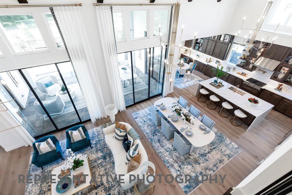 3908 Meander Way Prosper, TX 75078 - Photo 12 of 37 a living room with chairs and a wooden floor