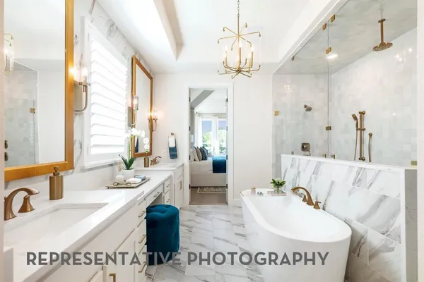 a spacious bathroom with a sink a large mirror and a bathtub
