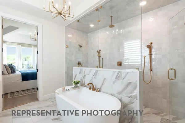 a en suite bathroom with a sink a mirror and a shower
