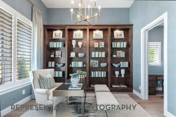a work room with furniture and a book shelf