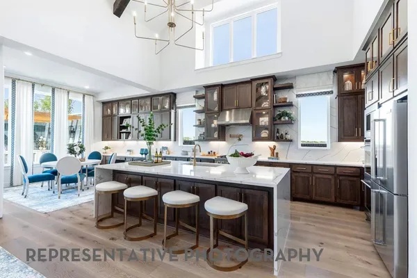 a large kitchen with a table and chairs