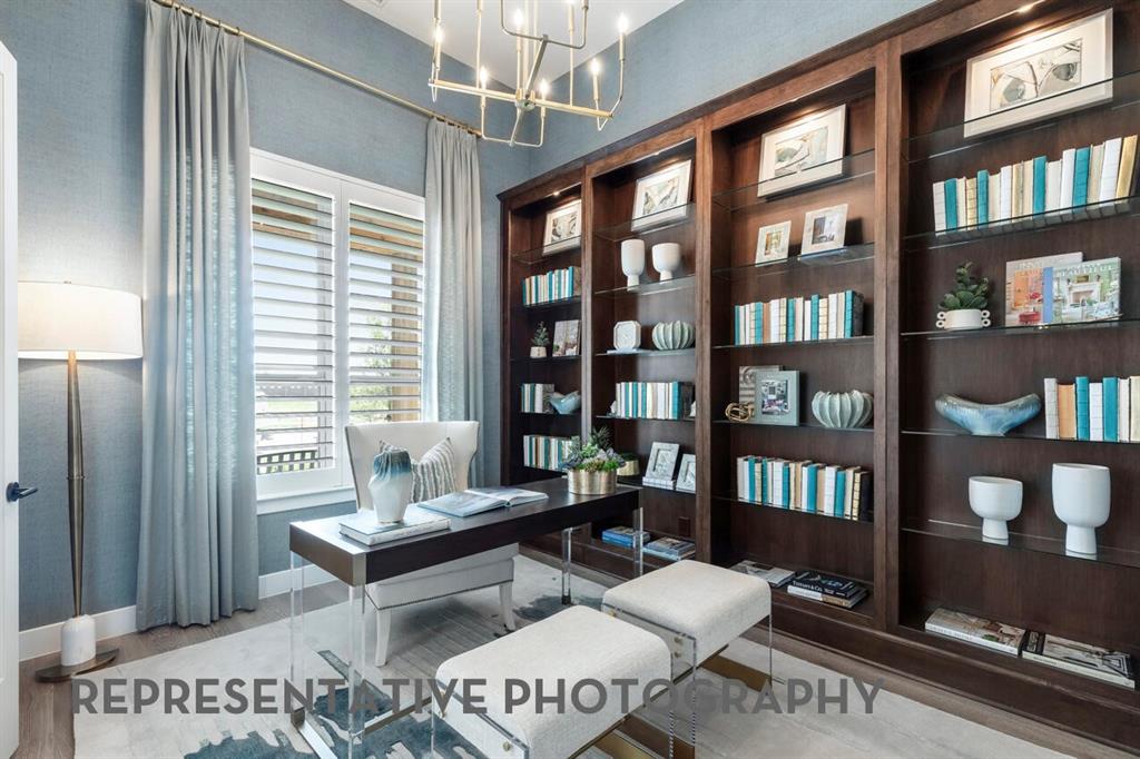 3908 Meander Way Prosper, TX 75078 - Photo 23 of 37 a living room with furniture a bookshelf and a window